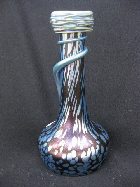 Loetz Art Glass Vase, snake style decoration on: snake style decoration on blue iridescent oil spot, 9 3/4", excellent.Loetz was a Bohemian company. It was a factory; and the region’s biggest and best glass manufacturer. There were other contempor