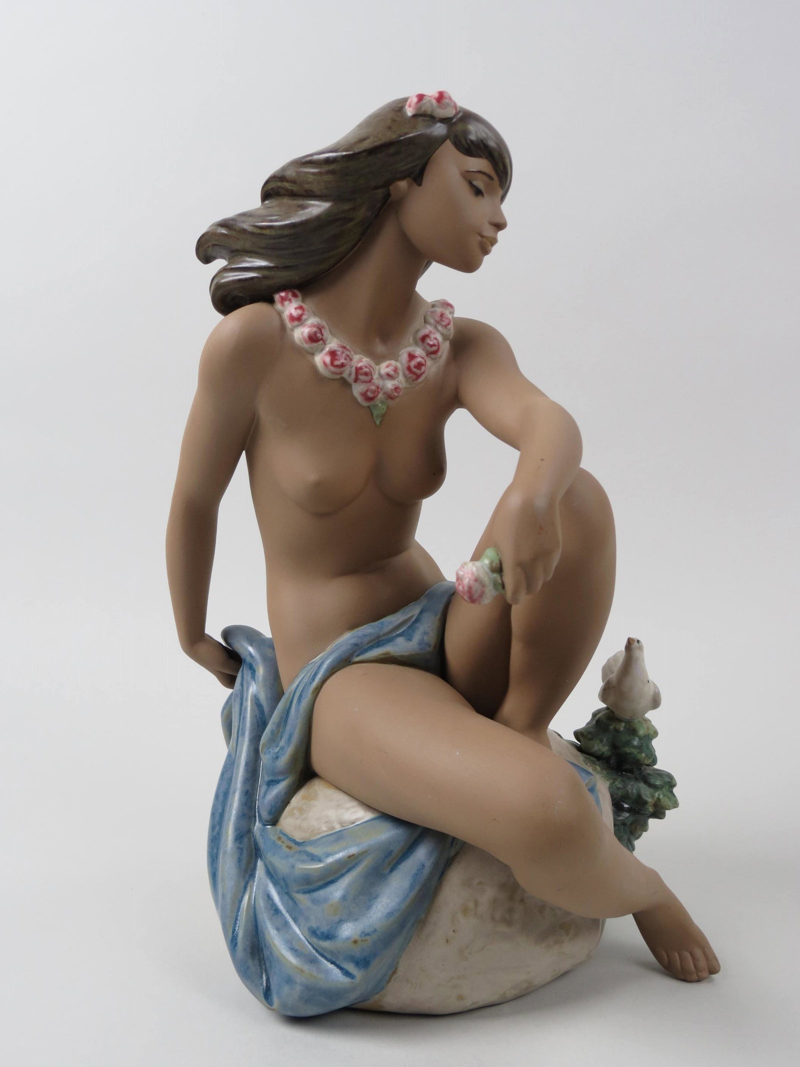 Lladro Figurine "Island Breeze",: #2394, young semi-nude female seated on rock, Gres finish, 14" tall, 1999, issued at $550.00, excellent.