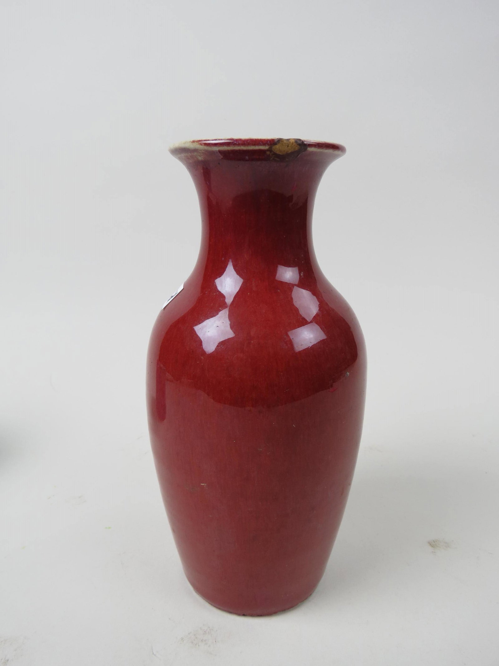 Chinese Sang de Boeuf Pottery Vase,: 9" tall, chip on top rim............. "sang-de-boeuf" (ox blood) were in use by the Chinese from the 11th century, and the effect was achieved by using copper oxide as a colouring agent and firing the