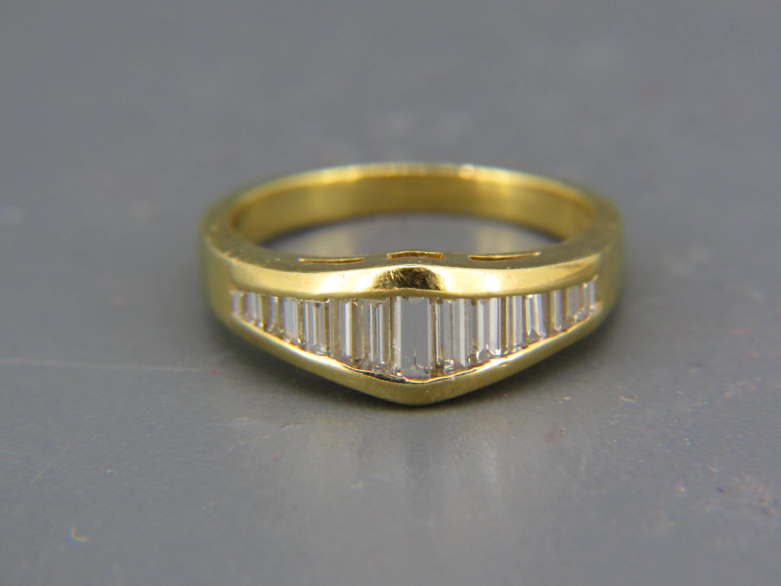 Diamond & 18K Yellow Gold Ring,: 15 tapered graduated baguette cut diamonds totaling approx. 1 carat , Italian, currently size 7.