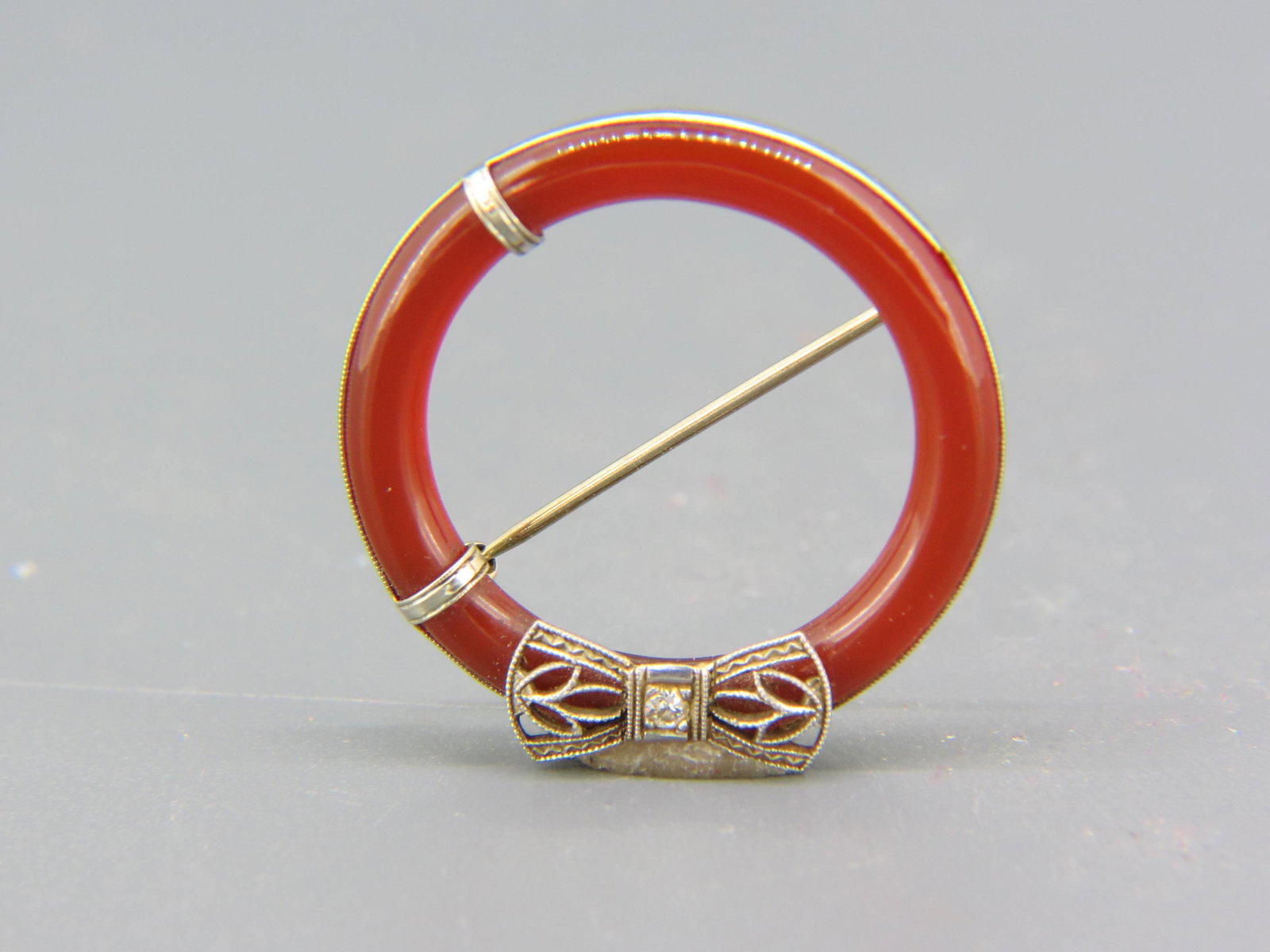 Diamond & Carnelian 14K Gold Brooch, Art Deco,: filigree bow with round diamond atop a cylindrical carnelian circle, 1 1/8" diameter, 3.2 grams, excellent.