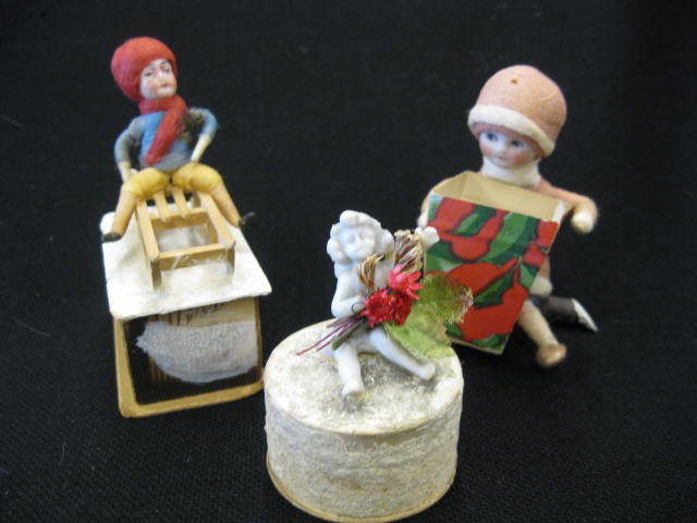 3 Antique Candy Containers, bisque head child on sl: bisque head child on sled, bisque head seated child & bisque miniature angel.