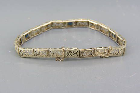 Diamond & 14K Gold Art Deco Filigree Bracelet,: two round diamonds and three synthetic blue sapphires in 14K white gold, 7.4 grams, 7" long.