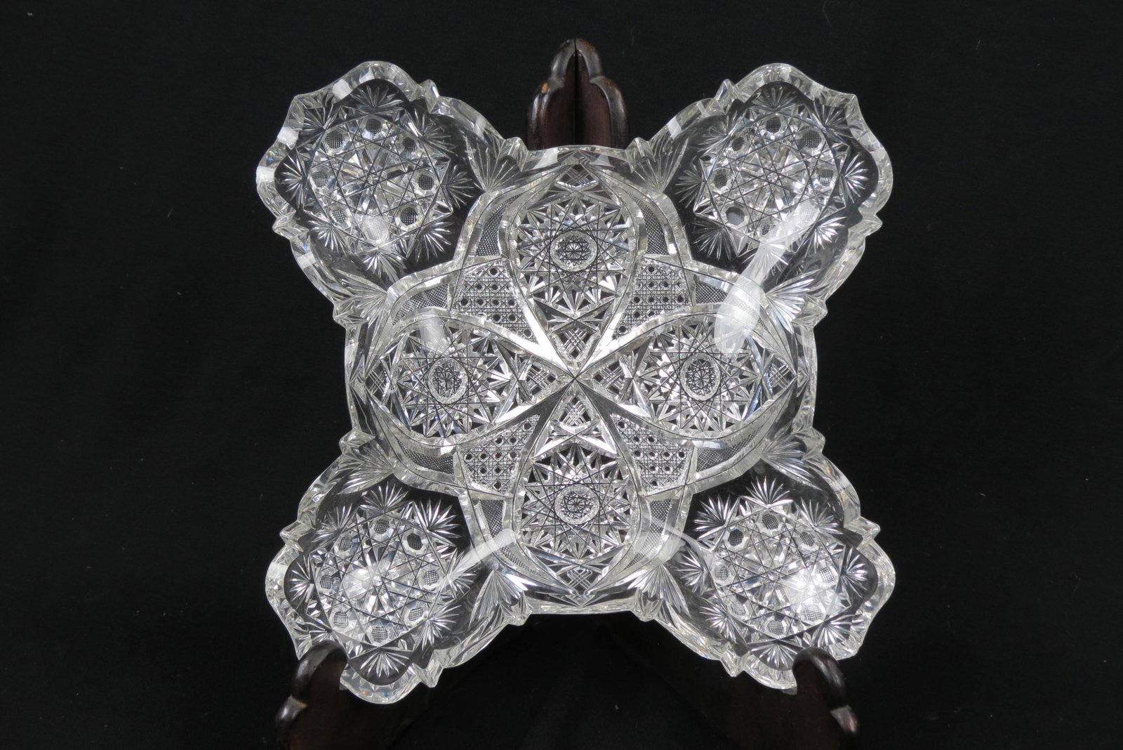 Unusual Cut Glass Dish, blown out wing shaping,: with feathered rays, button and cane, diamond point and other designs, 11" X 11", few rim flakes, brilliant period.