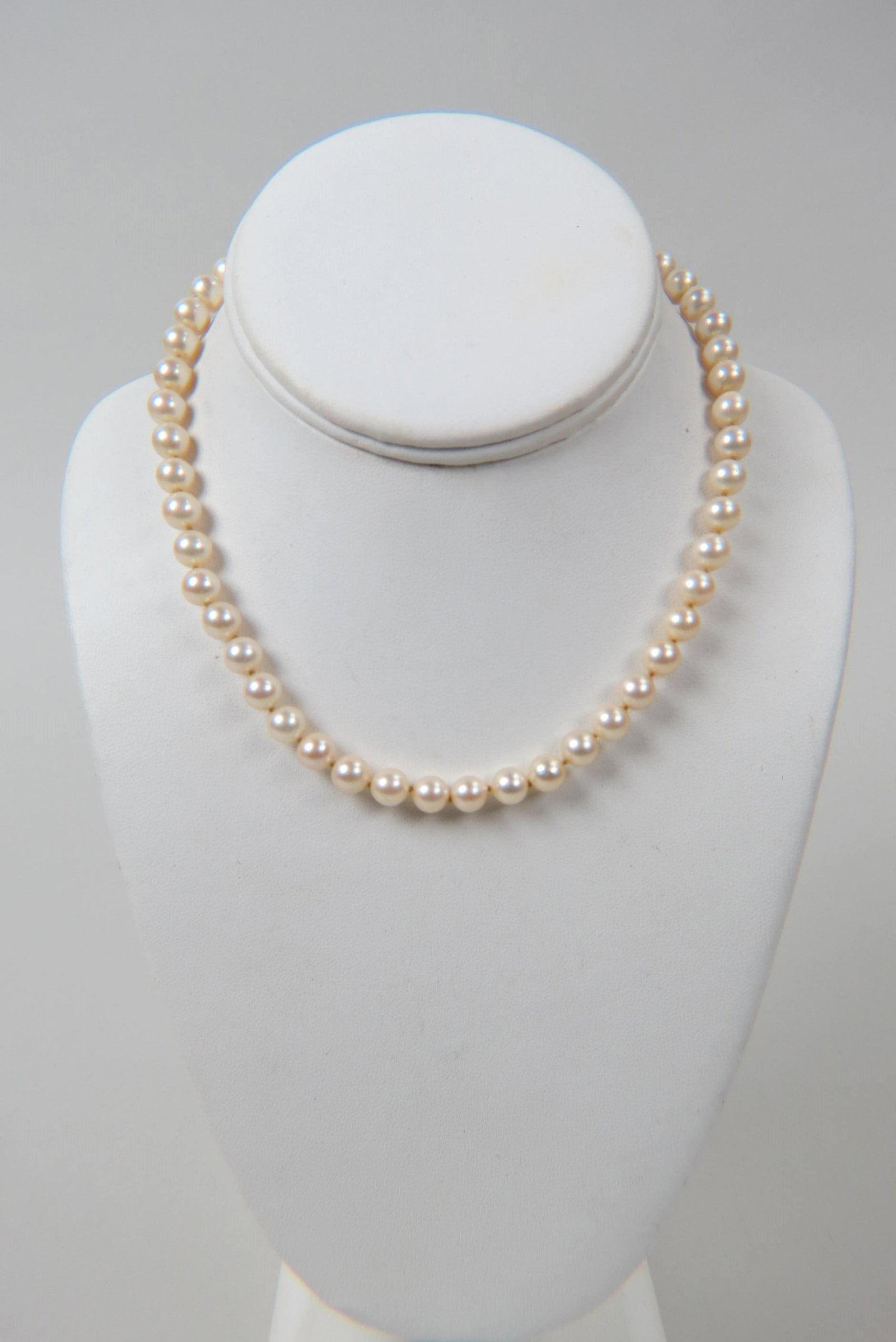 Pearl Necklace,: fine strand of 49 salt water cultured Akoya type pearls measuring 7.5 mm, silver clasp, 16" long.