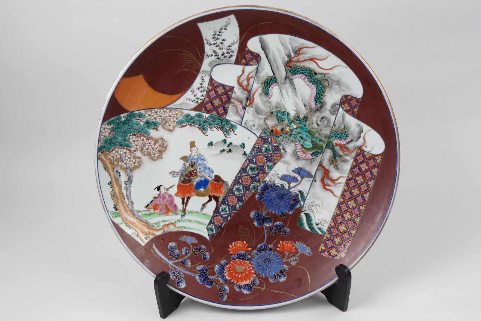 Japanese Imari Porcelain 18" Charger,: man on horseback with young Samurai by side, fierce dragon in clouds, decorated panels with flowers, exterior with cranes, excellent.............During the 17th and early 18th century Japanese porcela