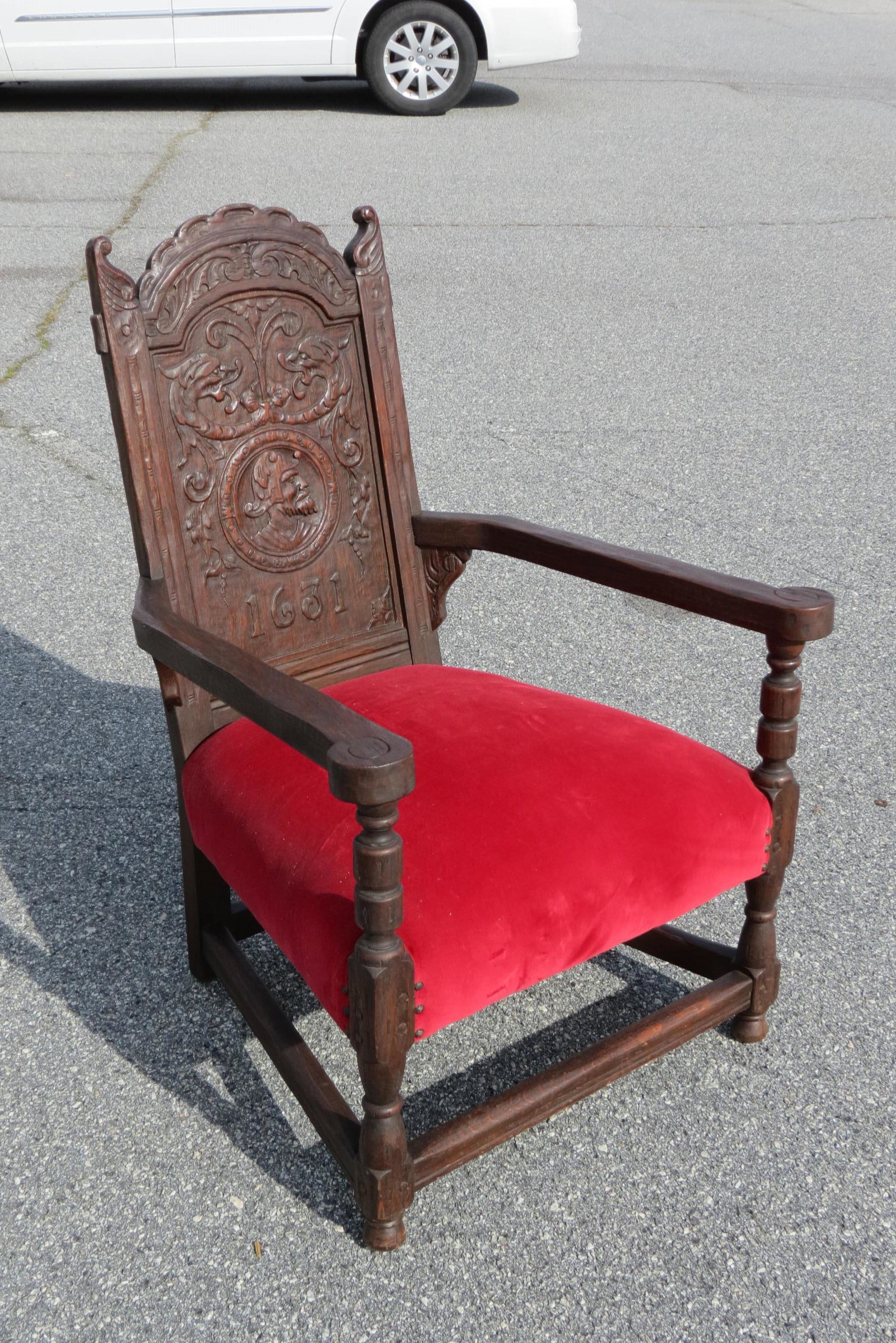 1631 English Oak Carved Arm Chair,: medallion of a man, dragon heads above, date below, 38 1/2" tall, 27 1/2" wide, 29" deep.