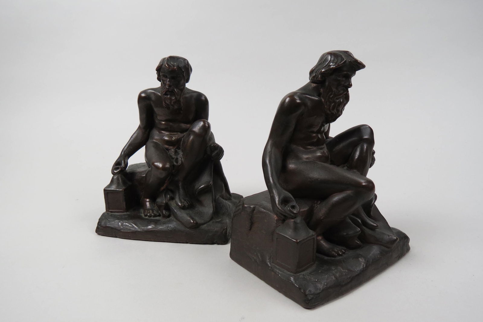 Pair of Bronze Figural Bookends of Old Man Seated,: lantern by his side, nude, Art Deco era, 7", excellent.