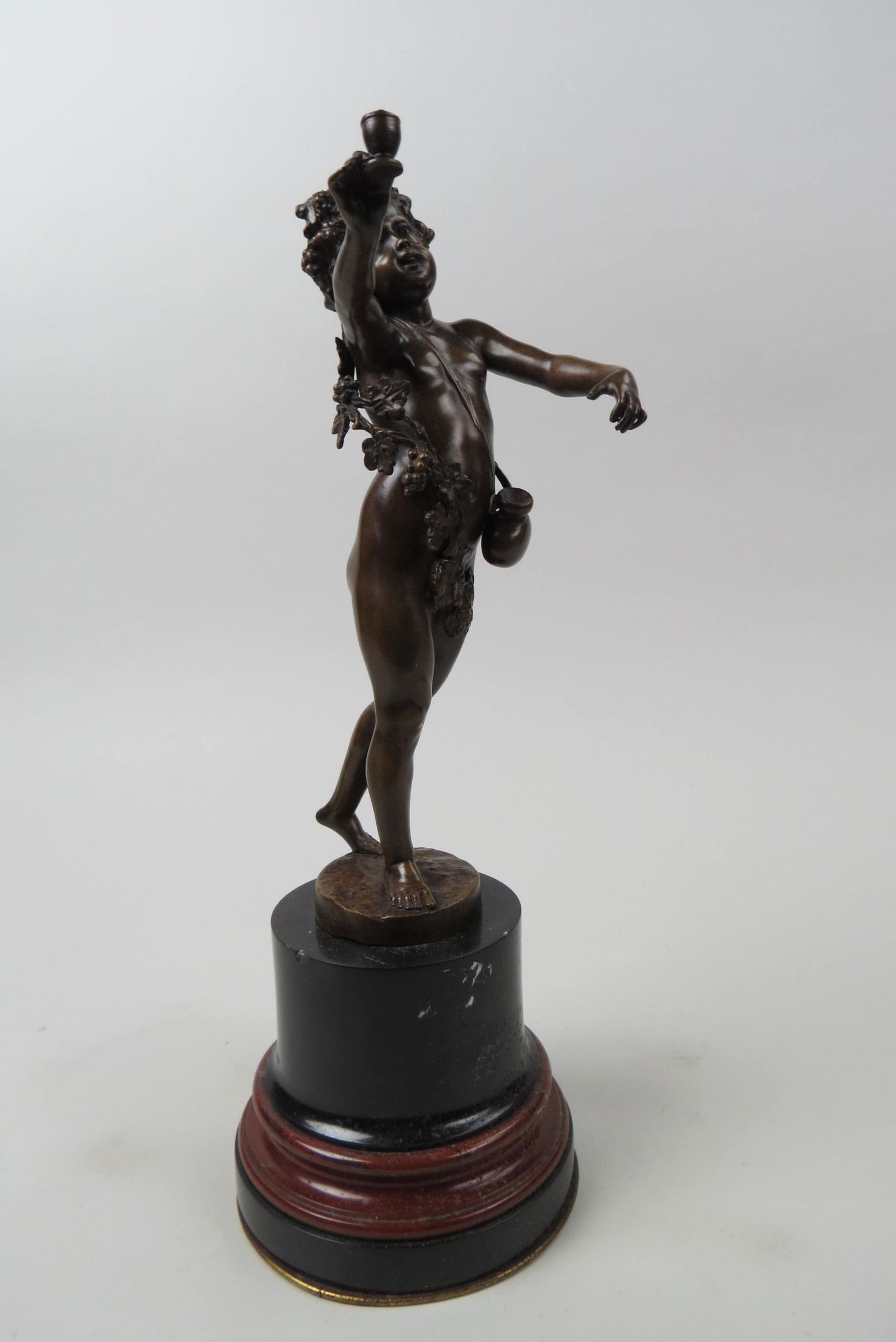 Bronze Statue of Nude Young Man by P. Konralzevski: he is carrying a vessel and holding a cup draped in grape and vine decor, marble base, 13 1/2" tall.