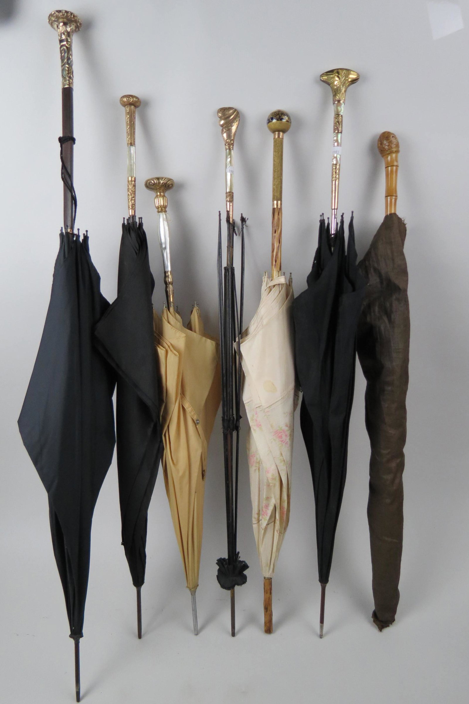 Collection of 7 Antique Umbrellas,: include fancy gold-filled and mother-of-pearl handles, Sevres porcelain, carved and more, 31 1/2" to 39".