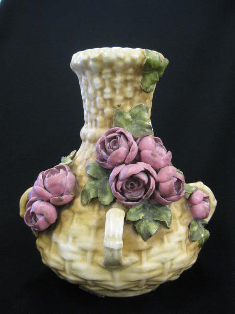 Amphora Austria Pottery Vase,: applied roses on basket weave design, handled, 10" tall, minor petal flakes.Amphora also refers to art pottery produced in the Turn-Teplitz region of Bohemia during the Art Nouveau era. These wares ar