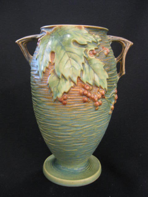 Roseville "Bushberry" Art Pottery Vase,: green, handled, #35-9", excellent.The company was founded by J.F. Weaver in Roseville, Ohio, in 1890. It was incorporated in 1892 with George Young, a former Roseville salesman, as secretary and gener
