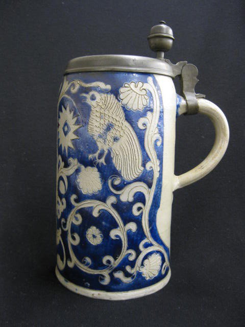 18th Century Stein, blue decorated stoneware: with carved bird & foliage, pewter lid, 11" tall