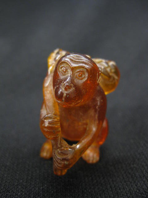 Amber Netsuke of a Monkey, fruit over his shoulde: shoulder, 1-3/4"