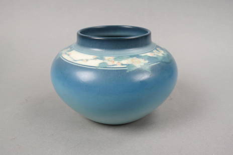 Rookwood Pottery Vase by Edward T. Hurley, 1926,: vellum glaze, floral band on fine blue to fade coloring background, shape #1929, 6 1/2" diameter, 4 1/2" tall, excellent....Note: Hurley was born in Cincinnati, Ohio, and studied at Xavier