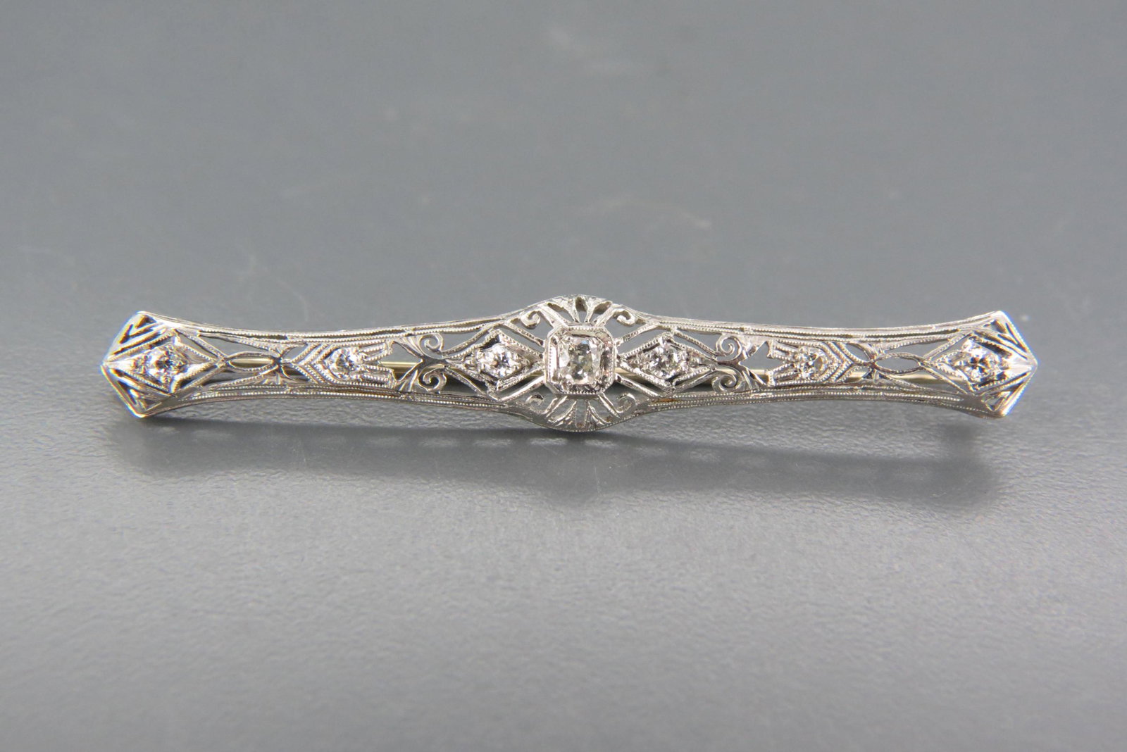 Platinum & Diamond Art Deco Bar Pin,: 7 old European cut round diamonds totaling .50 carat, with appraisal of $2,350.00, 2 1/2" wide.