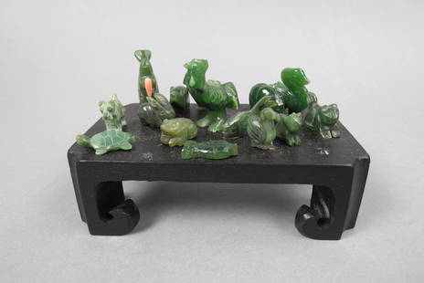 Collection of Carved Jade Miniatures of Animals: and Fish, mostly 1" size, 15 different, glued to wooden stand.
