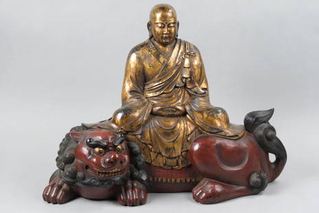 Japanese Carved Monju or Buddha on a Shishi,: gilded, lacquered and painted, Edo/Meiji period, 17 1/2" tall, 23" long, 10 1/2" deep.