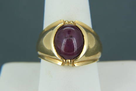 Men's Star Ruby & 14K Gold Ring,: oval double cabochon gem weighing 8.69 carats in yellow gold, 14.4 grams, with appraisal of $2,950.00, currently size 10.