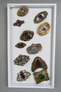 Collection of 11 Victorian Brooches,: mostly brass with faux stones, some Art Nouveau, most 2" X 3", 1890's.