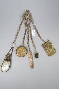 Victorian Chatelaine with Attachments,: includes perfume bottle, compact, pen knife, fob and dance card with pencil, elaborate brass designs including maiden with cupid and putti at play, circa 1880's............This is a chatelaine. It was