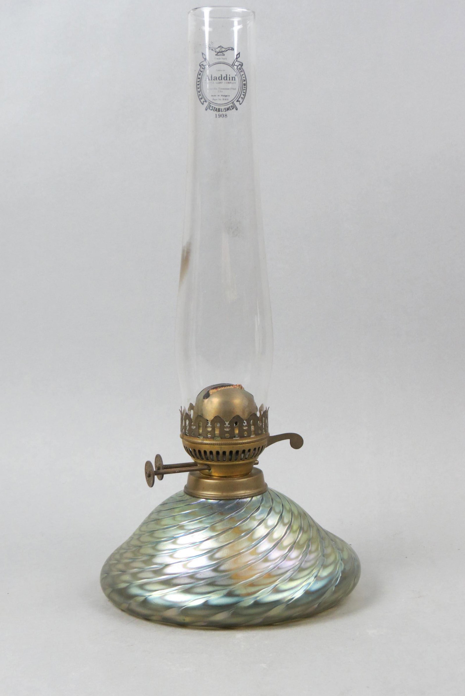 Studio Art Glass Oil Lamp,: iridescent swirling design on amber with silver and purple hues, 6" X 8" base with an Aladdin glass chimney, 17 1/2" overall.