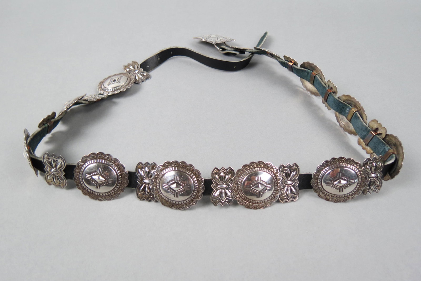 Ray Adakai Navajo Sterling Concho Belt,: signed by the well known Native American artist, conchos measure 1 3/4" X 1 1/2" each on 1/2" wide leather, currently holes for 29" to 31" size but can easily change out leather, 205 grams total.