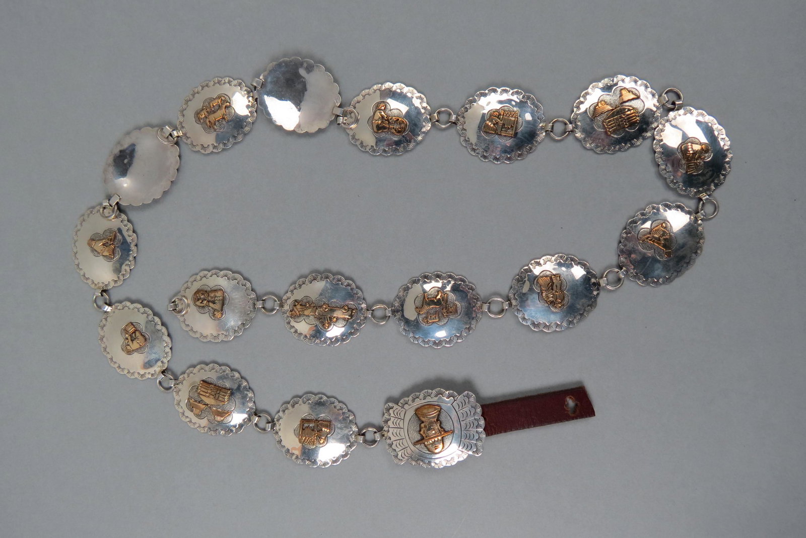 Navajo Sterling Concho Belt with Applied Designs,: mark of KK for Kathleen & Veronica Scott, gold filled overlay Western motifs on scalloped conchos, 39" long, 179 grams.