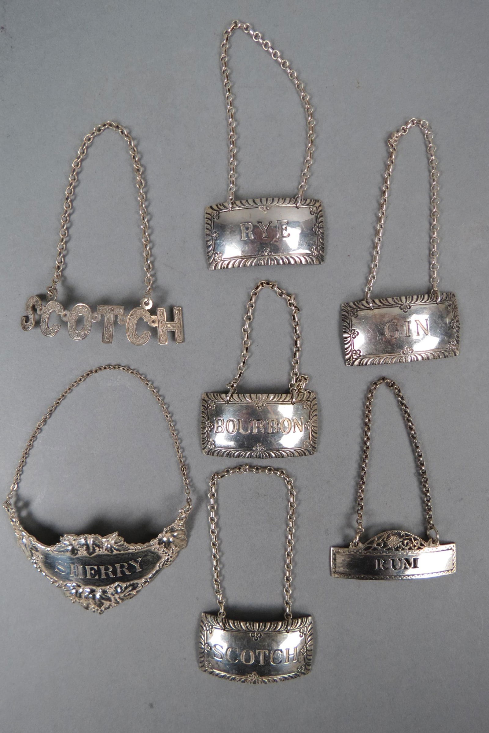 Collection of 7 Sterling Liquor Tags, (1 of 3)