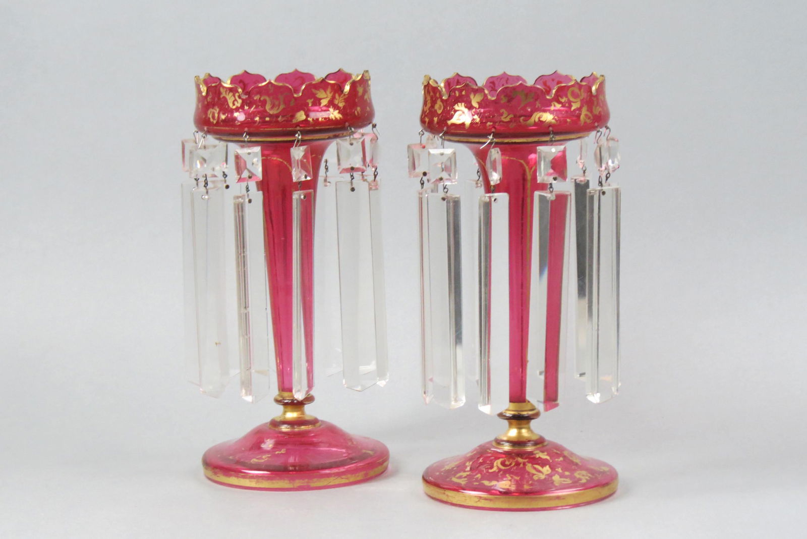 Pair of Bohemian Cranberry Glass Mantle Lusters,: long cut crystal prisms, 11 1/2" tall, some gold wear, late 19th century.