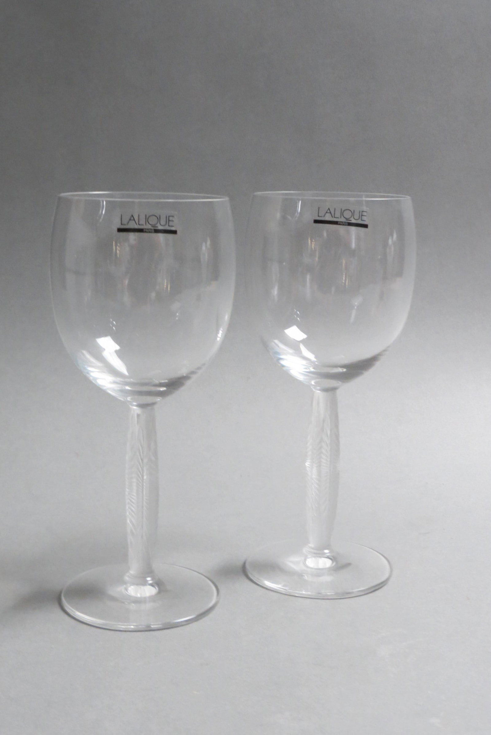 Pair of Lalique Crystal Wine Glasses "Diamond",: each with frosted stem having six facets, 7 1/2" tall, excellent, with original boxes.