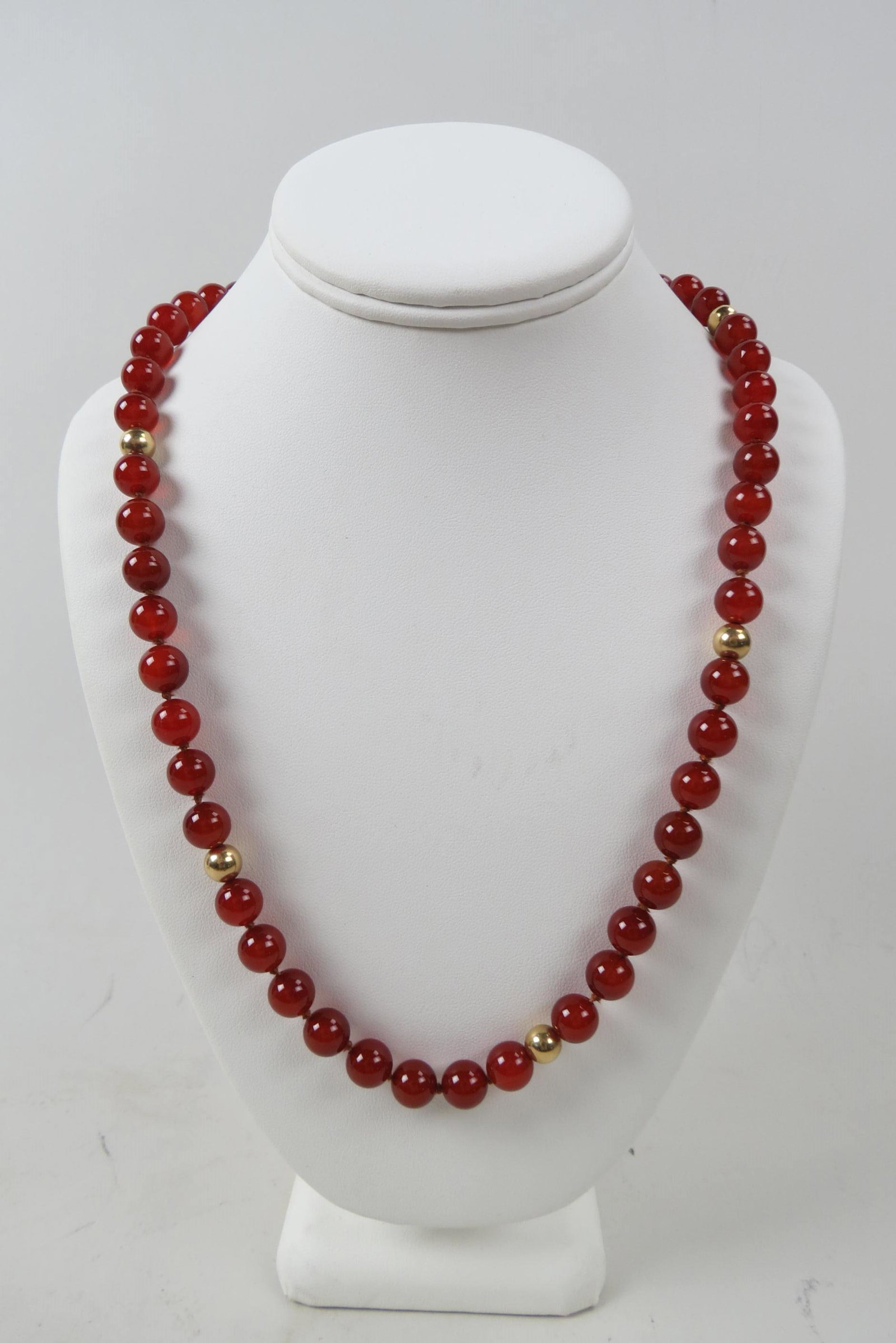 14K Gold & Carnelain or Red Jade Necklace,: 69 beads measuring 10 mm each with 8 14K yellow gold beads, 30" long.