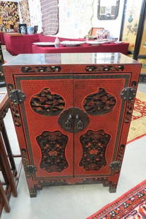 Japanese Lacquerware Cabinet with Flying Bats, Creatures,: with finely detailed cinnabar red decoration in field, symbols, flowers and foliage throughout, brass hinges and decoration, double doors, 36" tall, 24" wide, 12" deep.
