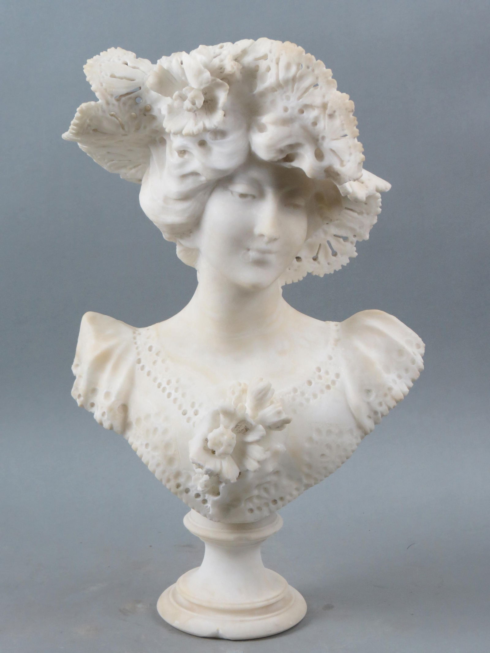 Carved Marble Bust of a Young Woman, wearing an elaborate lace hat, flowers around,  pedestal base, (1 of 6)