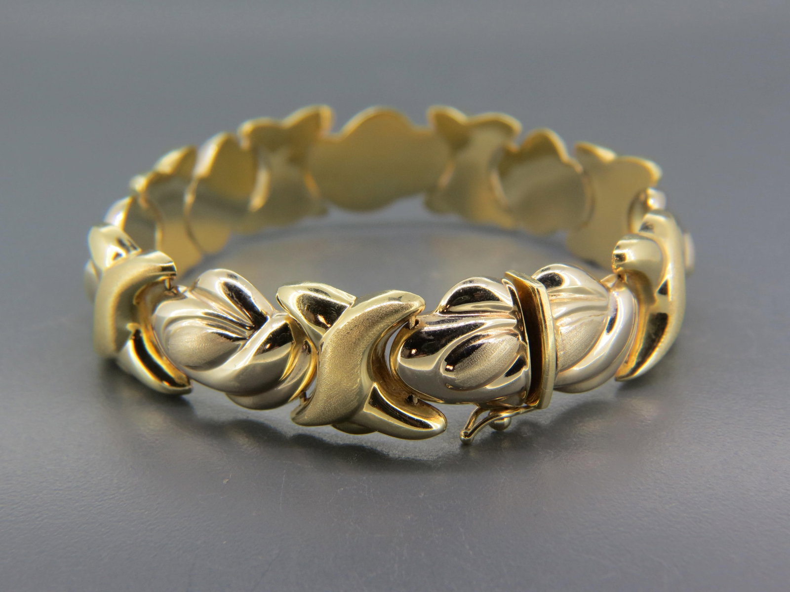 14K Gold Bracelet, yellow & rose gold linkage, brushed trim, over 1/2" wide, 7 1/2" long, 23.5: 14K Gold Bracelet, yellow & rose gold linkage, brushed trim, over 1/2" wide, 7 1/2" long, 23.5 grams.
