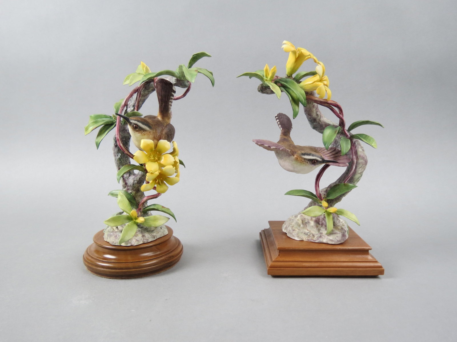 Pair of Royal Worcester Birds by Dorothy Doughty, "Beswick Wrens and Yellow Jasmine", male and: Pair of Royal Worcester Birds by Dorothy Doughty, "Beswick Wrens and Yellow Jasmine", male and female, issued in 1956, 9 3/4" plus wooden bases...Dorothy Doughty was born in San Remo, Italy in 1892. H