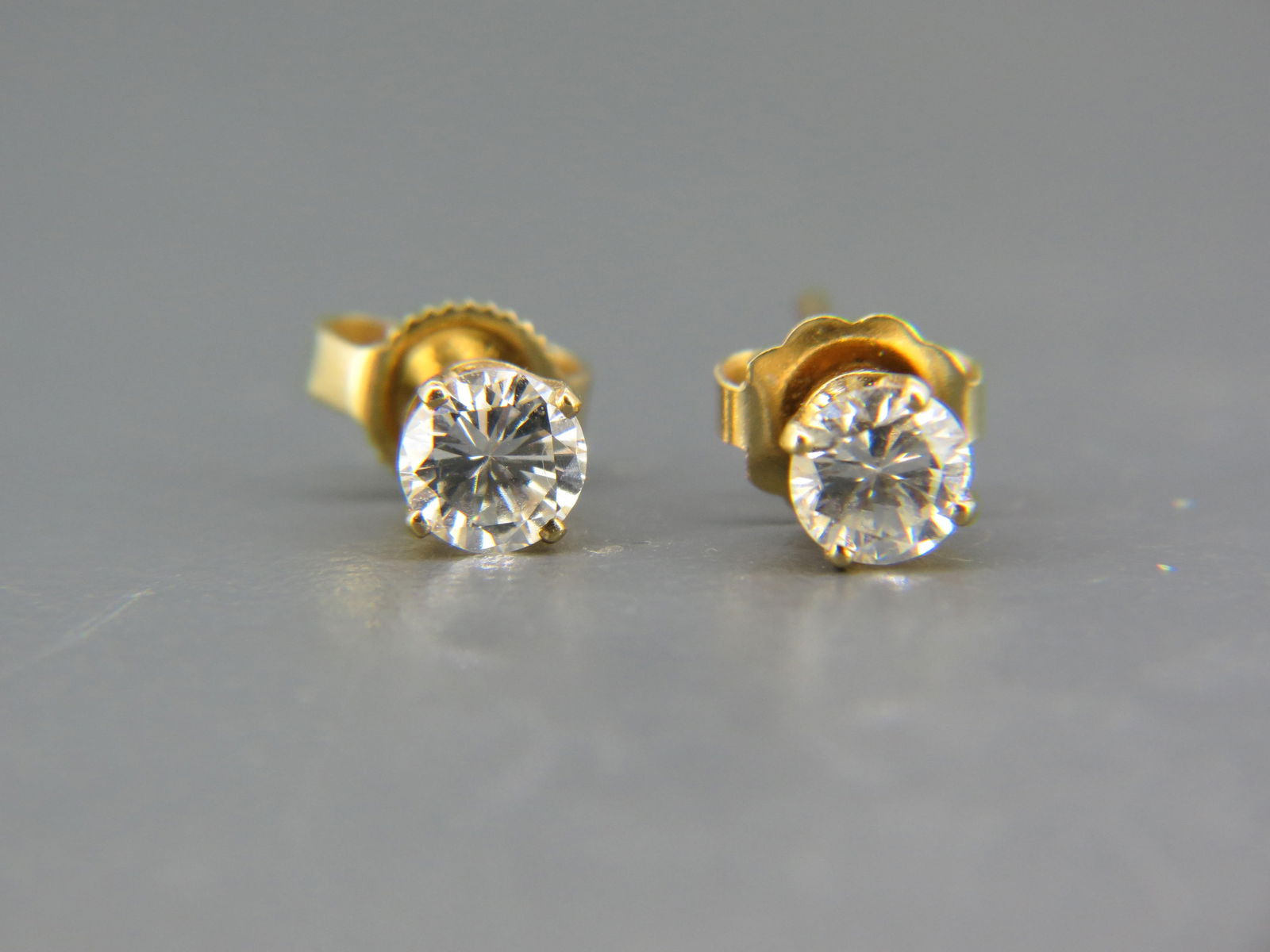Diamond Stud Earrings, two round brilliant diamonds totaling .67 carat in  14k yellow gold, with (1 of 5)
