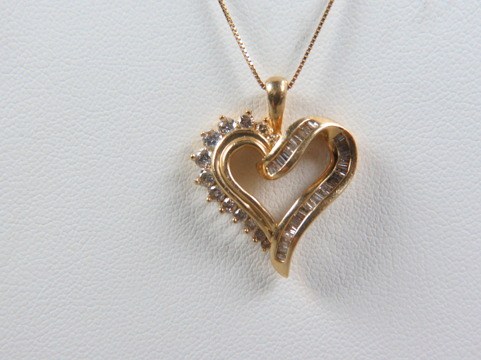 Diamond 14k Gold Heart Pendant & Chain, 42 round and baguette shape diamonds totaling 1 carat, all: Diamond 14k Gold Heart Pendant & Chain, 42 round and baguette shape diamonds totaling 1 carat, all 14k yellow gold, with appraisal of $2,550.00, 18" long.