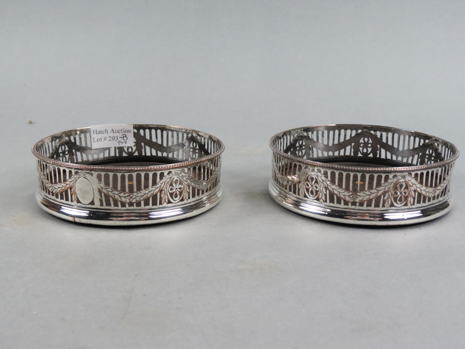 Pair of Silver on Copper Wine Coasters, English, openwork and garland design, 5" diameter, circa: Pair of Silver on Copper Wine Coasters, English, openwork and garland design, 5" diameter, circa 1900.
