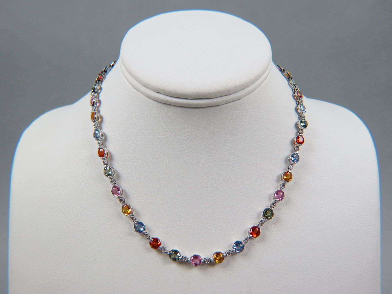 Sapphire & Diamond 14k Gold Necklace, 40 oval sapphires in various colors totaling 17.23 carats: Sapphire & Diamond 14k Gold Necklace, 40 oval sapphires in various colors totaling 17.23 carats with 40 round diamonds totaling .29 carat, high grade, 14k white gold, with appraisal of $3,950.00, 16 1