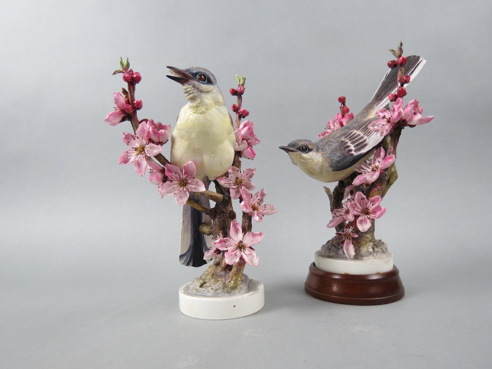 Pair of Royal Worcester Birds by Dorothy Doughty, "Mockingbirds and Peach Blossoms", male and: Pair of Royal Worcester Birds by Dorothy Doughty, "Mockingbirds and Peach Blossoms", male and female, issued in 1940, 10 1/2", with original wooden boxes.....Dorothy Doughty was born in San Remo, Ital