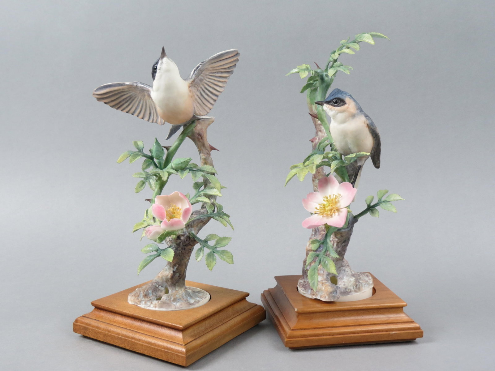 Pair of Royal Worcester Birds by Dorothy Doughty, "Lesser White Throats & Wild Roses", male and: Pair of Royal Worcester Birds by Dorothy Doughty, "Lesser White Throats & Wild Roses", male and female, issued in 1964, 9 1/2" tall plus wooden bases, with original wooden boxes.....Dorothy Doughty wa