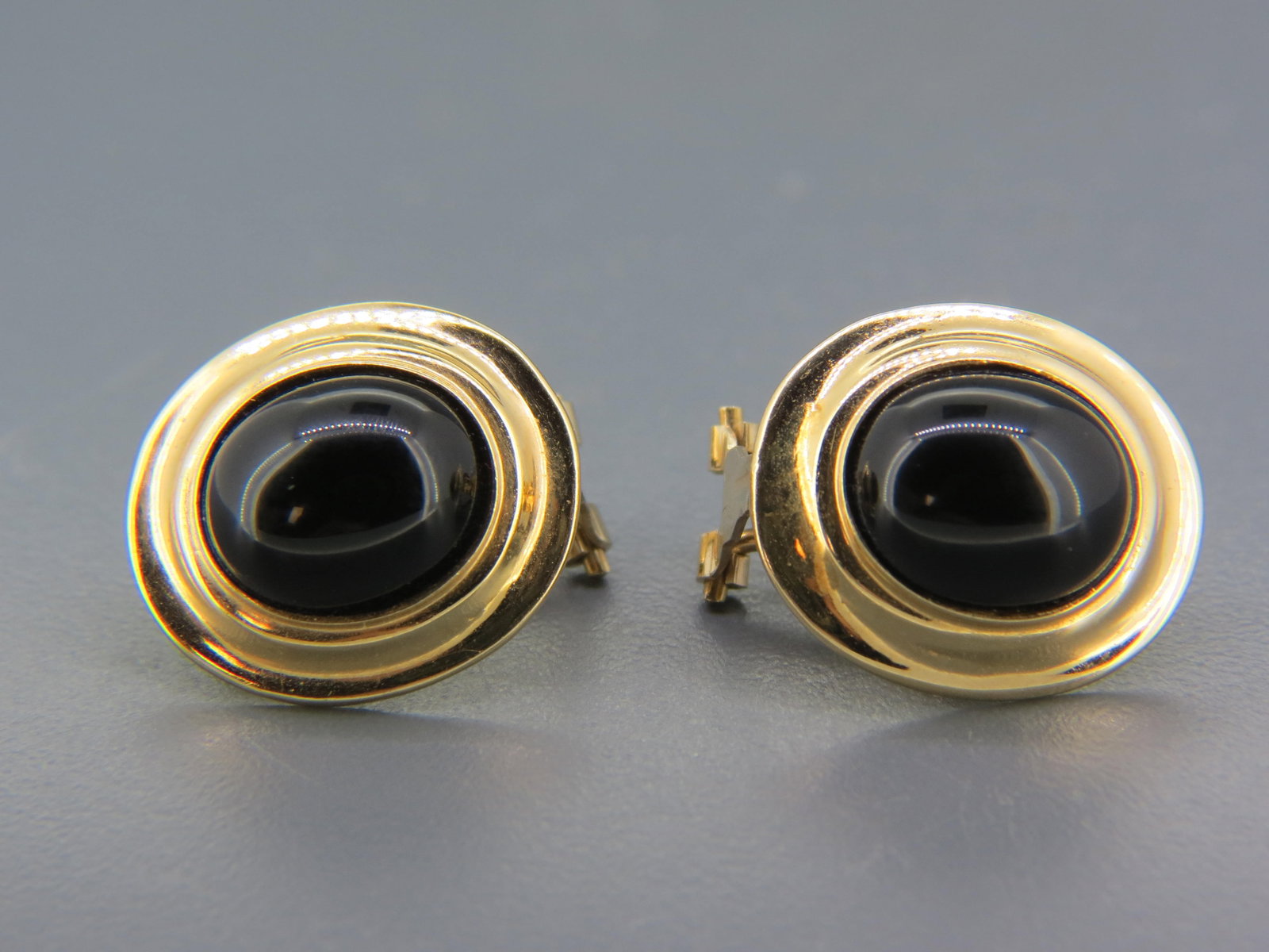 Black Onyx 14K Gold Earrings, oval cabochons in 14K yellow gold, post & clip closures, 7 grams,: Black Onyx 14K Gold Earrings, oval cabochons in 14K yellow gold, post & clip closures, 7 grams, 7/8" long.