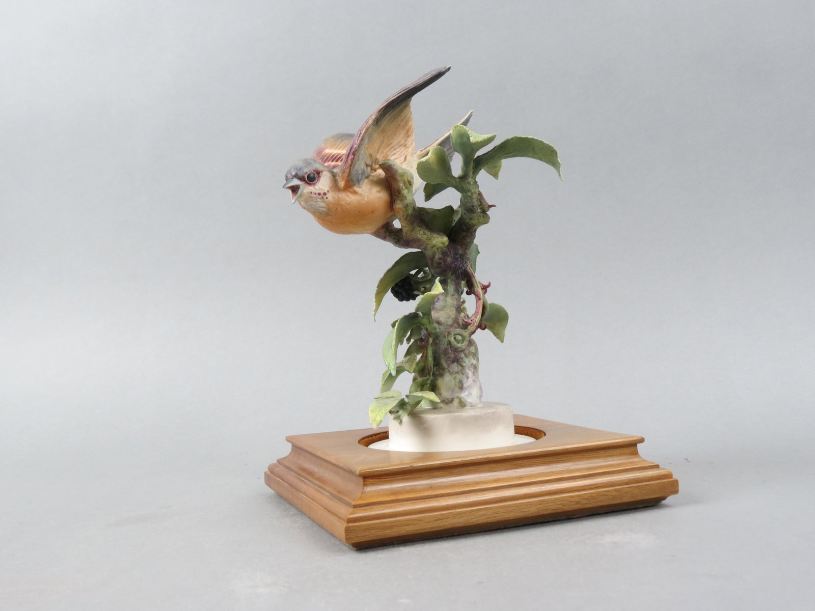 Royal Worcester Bird Figurine by Dorothy Doughty, "Indigo Bunting & Blackberry Sprays", 8" plus wood: Royal Worcester Bird Figurine by Dorothy Doughty, "Indigo Bunting & Blackberry Sprays", 8" plus wood base..........Dorothy Doughty was born in San Remo, Italy in 1892. Her father was the explorer and 
