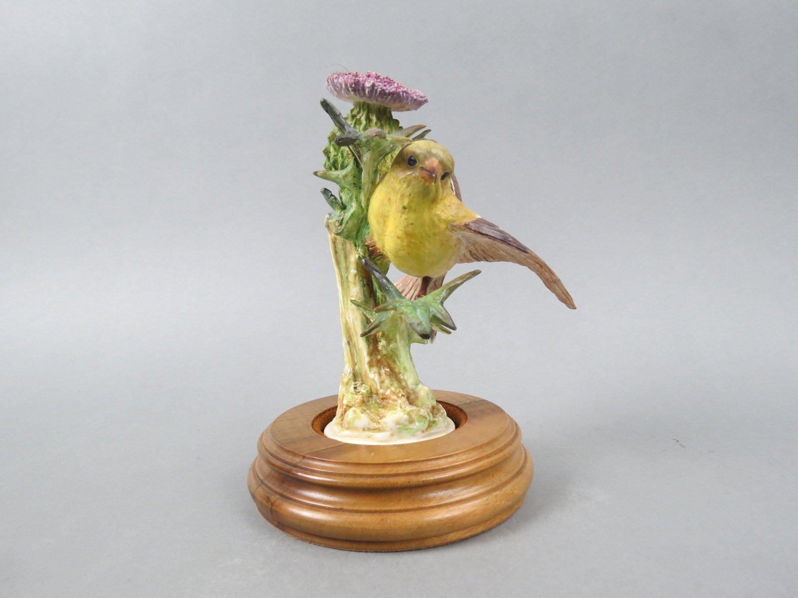 Royal Worcester Bird Figurine by Dorothy Doughty, "American Goldfinch & Thistle, issued 7 1/4" plus: Royal Worcester Bird Figurine by Dorothy Doughty, "American Goldfinch & Thistle, issued 7 1/4" plus wood base. issued in 1936, only 250 made...Dorothy Doughty was born in San Remo, Italy in 1892. Her 