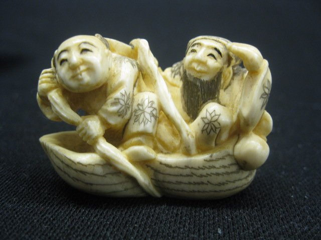 Chinese Carved Ivory Netsuke of Two Men in a nut: shaped boat, fancy polychrome details, 2 1/4" long, 1 3/8" tall, excellent.