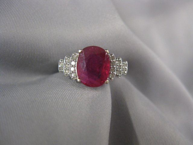 Ruby & Diamond Ring,: oval gem approx. 2 carats and 18 diamonds in 10k white gold, currently size 8.