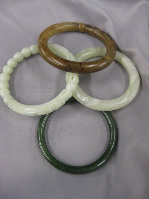 Jade Bangle Bracelet, estate lot: of 4 different including, carved, one 2 1/4" opening others are 2 1/2" opening.