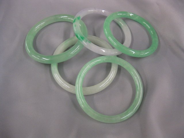 5 Jade Bangle Bracelets, estate lot,: mostly mottled greens, on having some lavender, 2" opentings.