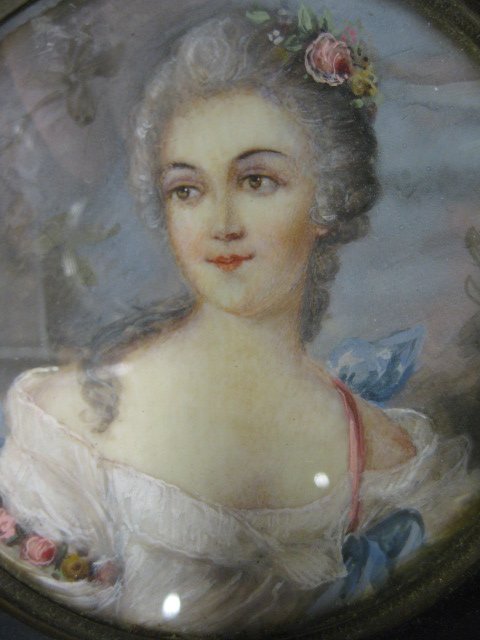 Miniature Painting on Ivory of a Young Lady, arti: artist signed, 3 1/4" diameter, ebonized frame with bronze ring, 19th century.